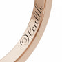 Close-up of inner engraving on a Dimis Designs 18K rose gold square ring with hand-engraved words