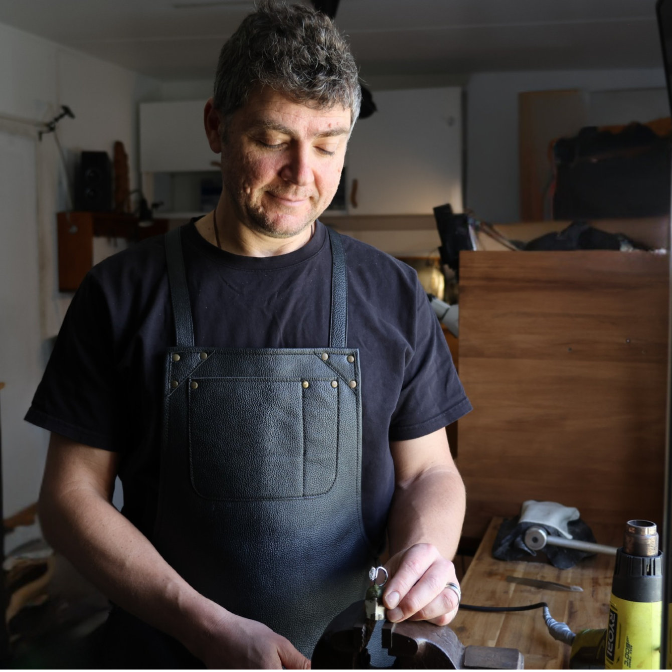 Dimitar, second-generation artisan master jeweller and founder of Dimis Designs, carefully working on a diamond ring at his jewellery workbench in Brisbane.